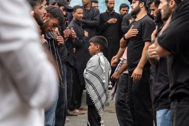July 19, 2026, Budgam, Jammu And Kashmir, India: A boy wearing a Palestinian keffiyeh, a traditional Middle Eastern scarf, takes part in a religious procession on the fourth day of Safar in Magam. Safar, the second month of the Islamic calendar, follows Muharram and continues the mourning of Imam Hussain. According to Shia tradition, the 4th of safar, 61 AH, marks the imprisonment of the Prophet s household (Ahl al-Bayt) in Kufa under the orders of Ubaydullah ibn Ziyad after the Battle of Karbala. Budgam India  - ZUMAa205 20260719_zip_a205_011 Copyright: xAdilxAbassx