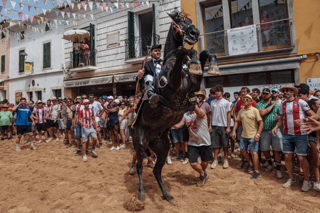 July 19, 2026, Es Mercadal, Menorca Balearic Islands, Spain: A caixer, or horse rider, rears his horse amid a cheering crowd during the traditional Jaleo at the Sant MartoÂ­ Festival in Es Mercadal. Es Mercadal Spain - ZUMAo105 20260719_fap_o105_014 Copyright: xMatthiasxOesterlex