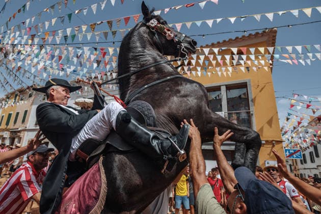 July 19, 2026, Es Mercadal, Menorca Balearic Islands, Spain: A caixer, or horse rider, rears his horse amid a cheering crowd during the traditional Jaleo at the Sant MartoÂ­ Festival in Es Mercadal. Es Mercadal Spain - ZUMAo105 20260719_fap_o105_015 Copyright: xMatthiasxOesterlex