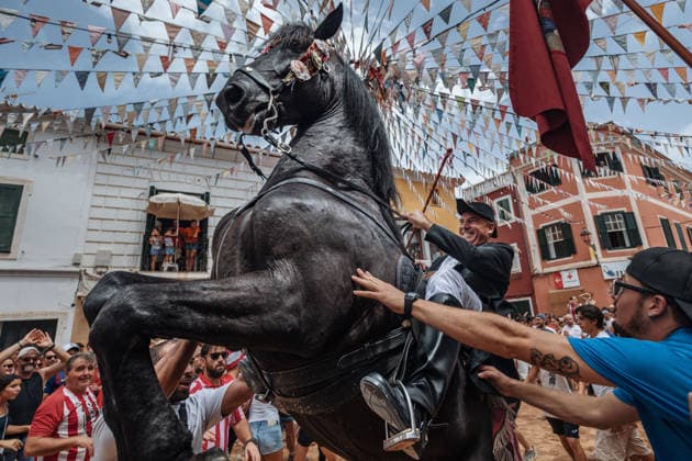 July 19, 2026, Es Mercadal, Menorca Balearic Islands, Spain: A caixer, or horse rider, rears his horse amid a cheering crowd during the traditional Jaleo at the Sant MartoÂ­ Festival in Es Mercadal. Es Mercadal Spain - ZUMAo105 20260719_fap_o105_028 Copyright: xMatthiasxOesterlex