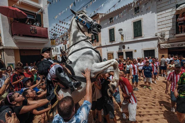 July 19, 2026, Es Mercadal, Menorca Balearic Islands, Spain: A caixer, or horse rider, rears his horse amid a cheering crowd during the traditional Jaleo at the Sant MartoÂ­ Festival in Es Mercadal. Es Mercadal Spain - ZUMAo105 20260719_fap_o105_026 Copyright: xMatthiasxOesterlex