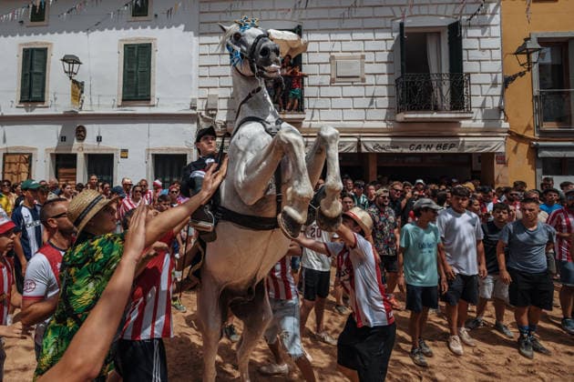 July 19, 2026, Es Mercadal, Menorca Balearic Islands, Spain: A caixer, or horse rider, rears his horse amid a cheering crowd during the traditional Jaleo at the Sant MartoÂ­ Festival in Es Mercadal. Es Mercadal Spain - ZUMAo105 20260719_fap_o105_031 Copyright: xMatthiasxOesterlex