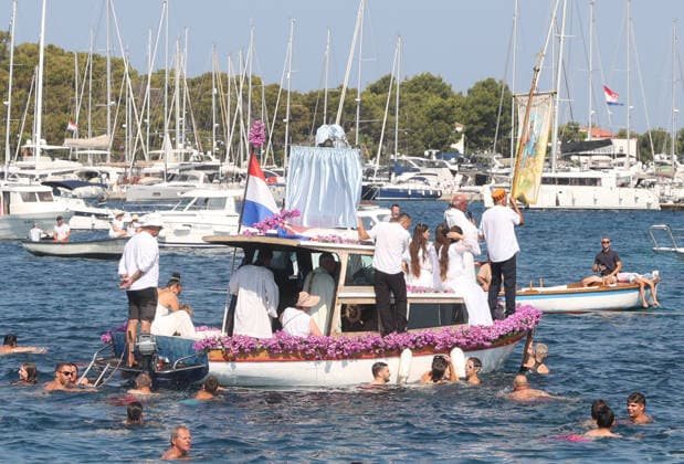 Traditional return of Gospa od Kapelice to shrine in Rogoznica Believers take part in the traditional return of the Marian image Gospa od Kapelice to its shrine on the Gradina peninsula in Rogoznica, Croatia, on July 19, 2026, after the image spent time in the parish church. The image is carried in a procession by sea and land, accompanied by worshippers, swimmers and boats.  DuskoxJaramaz PIXSELL