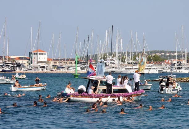 Traditional return of Gospa od Kapelice to shrine in Rogoznica Believers take part in the traditional return of the Marian image Gospa od Kapelice to its shrine on the Gradina peninsula in Rogoznica, Croatia, on July 19, 2026, after the image spent time in the parish church. The image is carried in a procession by sea and land, accompanied by worshippers, swimmers and boats.  DuskoxJaramaz PIXSELL