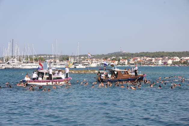 Traditional return of Gospa od Kapelice to shrine in Rogoznica Believers take part in the traditional return of the Marian image Gospa od Kapelice to its shrine on the Gradina peninsula in Rogoznica, Croatia, on July 19, 2026, after the image spent time in the parish church. The image is carried in a procession by sea and land, accompanied by worshippers, swimmers and boats.  DuskoxJaramaz PIXSELL