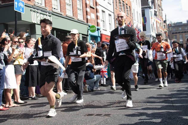 SOHO Waiters Race at SOHO, London, UK - Sun 19 July 2026 Waiters from various London restaurants take part in the annual SOHO Waiters Race, balancing a champagne bottle and a glass around SOHO in London, England, UK on Sunday 19 July 2026 as part of the SOHO Village Fete., Credit:Justin Ng Avalon UK, England, London, SOHO  Copyright: xJustinxNgx xAvalonx 1117372146