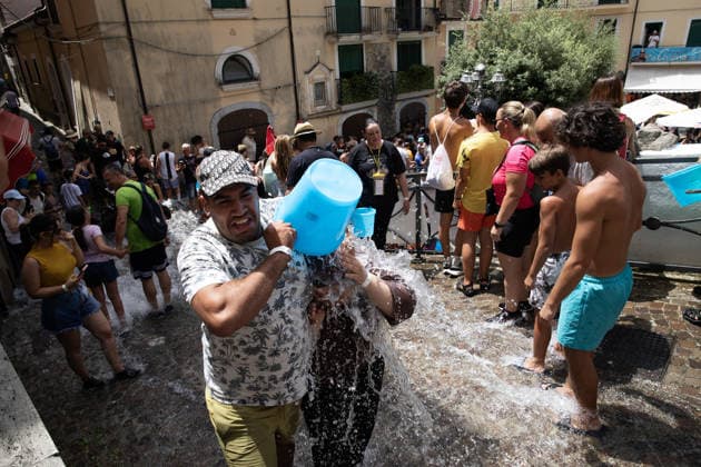 La Chiena traditional summer war with water in Italy CAMPAGNA, ITALY - JULY 19: People throw buckets of water at each other during the event called La Chiena , one of the most characteristic traditions of Campagna, near Salerno, Italy on July 19, 2026. During the summer, the waters of the Tenza River are diverted through an ancient artificial canal and made to flow along the streets of the historic center. This custom was born centuries ago with the aim of cleaning the streets from dust and waste. Iso Ekle Anadolu Campania Italy. Editorial use only. Please get in touch for any other usage.  Copyright: x2026xAnadoluxIsoxEklex