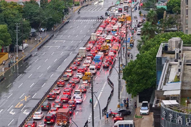 SHANGHAI, CHINA - JULY 19: Cars drive through flooded street due to heavy rainstorms on July 19, 2026 in Shanghai, China. Shanghai Meteorological Observatory upgraded the rainstorm alert from yellow to orange for the central urban area at 14:35 on July 19.  Copyright: xVCGx 111655214002
