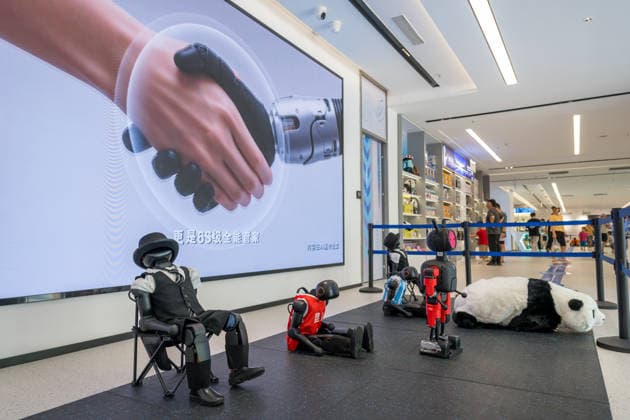 KUNSHAN, CHINA - JULY 19: People visit a robot 6S store on its opening day on July 19, 2026 in Kunshan, Jiangsu Province of China. The store offers integrated sales, spare parts, after-sales service, feedback, leasing, and customization services while serving as a hub for humanoid robots, drones, training, and industry incubation.  Copyright: xVCGx 111655192692