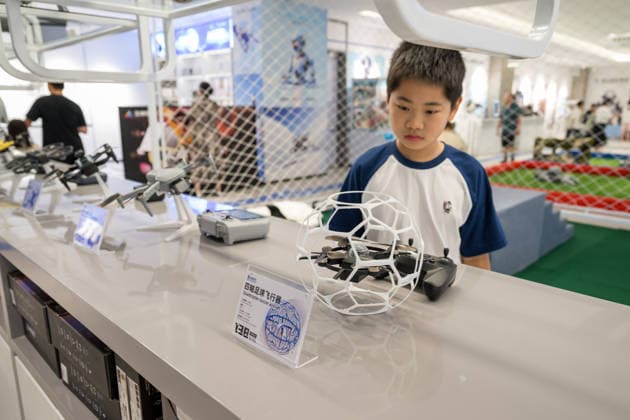 KUNSHAN, CHINA - JULY 19: People visit a robot 6S store on its opening day on July 19, 2026 in Kunshan, Jiangsu Province of China. The store offers integrated sales, spare parts, after-sales service, feedback, leasing, and customization services while serving as a hub for humanoid robots, drones, training, and industry incubation.  Copyright: xVCGx 111655192666