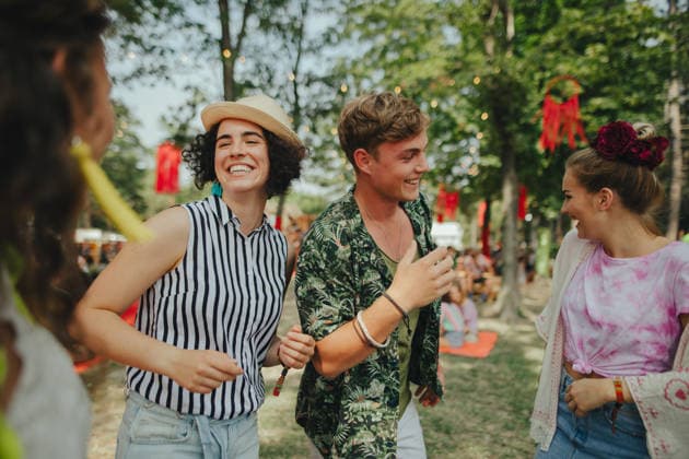 Group of young friends at summer festival. Group of cheerful young friends at summer festival, looking at camera. model released