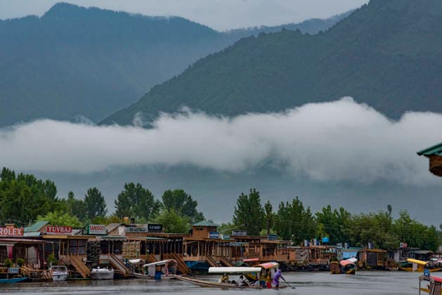 July 20, 2026, Srinagar, Jammu And Kashmir, India: A man rows his Shikara boat during heavy rainfall in Srinagar.Torrential rain unleashed flash floods and landslides in Pir Panjal region of J&Ks Poonch and Rajouri districts Sunday, killing at least 14 people, leaving several missing and burying homes under walls of water, rock and mud that barrelled down mountain slopes. Officials said the toll could rise as rescuers searched for those trapped beneath debris. Srinagar India  - ZUMAz120 20260720_zip_z120_001 Copyright: xBasitxZargarx