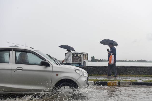July 20, 2026, Srinagar, Jammu And Kashmir, India: People walk witn their umbrellas during heavy rainfall in Srinagar.Torrential rain unleashed flash floods and landslides in Pir Panjal region of J&Ks Poonch and Rajouri districts Sunday, killing at least 14 people, leaving several missing and burying homes under walls of water, rock and mud that barrelled down mountain slopes. Officials said the toll could rise as rescuers searched for those trapped beneath debris. Srinagar India  - ZUMAz120 20260720_zip_z120_010 Copyright: xBasitxZargarx