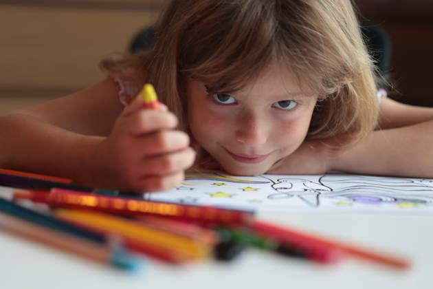 Young girl coloring a unicorn picture with playful expression Ústí nad Orlicí, Pardubice Region, Czechia CR_ILUS260717-2081604-01 ,model released, Symbolfoto ,property released