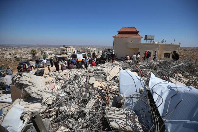 Israeli forces demolish Palestinian home in West Bank HEBRON, PALESTINE - JULY 20: Palestinians gather on the rubble after Israeli forces demolished the home of Palestinian Ahmed Masalmeh in the town of Beit Awwa, west of Hebron in the occupied West Bank, on July 20, 2026. The house was demolished on the grounds that it had been built without a permit. Residents mourned and inspected the debris following the demolition. Wisam Hashlamoun Anadolu Hebron West Bank. Editorial use only. Please get in touch for any other usage.  Copyright: x2026xAnadoluxWisamxHashlamounx