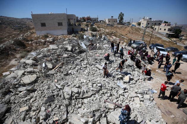 Israeli forces demolish Palestinian home in West Bank HEBRON, PALESTINE - JULY 20: Palestinians gather on the rubble after Israeli forces demolished the home of Palestinian Ahmed Masalmeh in the town of Beit Awwa, west of Hebron in the occupied West Bank, on July 20, 2026. The house was demolished on the grounds that it had been built without a permit. Residents mourned and inspected the debris following the demolition. Wisam Hashlamoun Anadolu Hebron West Bank. Editorial use only. Please get in touch for any other usage.  Copyright: x2026xAnadoluxWisamxHashlamounx
