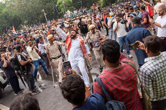 July 20, 2026, New Delhi, Delhi, India: Supporters of India s Cockroach Janta Party (CJP) gather before a march to Parliament during a protest demanding the resignation of Education Minister Dharmendra Pradhan over alleged exam paper leaks. Members of the Rapid Action Force (RAF) are deployed at the protest site near Jantar Mantar in New Delhi, India. New Delhi India  - ZUMAt180 20260720_zip_t180_018 Copyright: xJaixThakurx