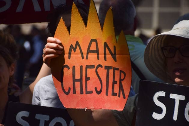 July 20, 2026, London, England, United Kingdom: A protester holds a Manchester burning sign as climate activists from the group Fossil Free London stage a protest outside Downing Street against Rosebank and other oil and gas projects in the North Sea ahead of the arrival of Andy Burnham, who replaces Keir Starmer as the UK Prime Minister. London United Kingdom - ZUMAv130 20260720_zip_v130_026 Copyright: xVukxValcicx
