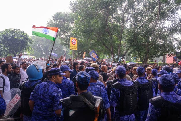 July 20, 2026, New Delhi, New Delhi, India: NEW DELHI, India Ã¢â‚¬ Rapid Action Force (RAF) personnel in riot gear stand in large numbers as protesters wave the national flag and raise slogans near Connaught Place, during demonstrations by the Cockroach Janata Party (CJP) demanding the resignation of Education Minister Dharmendra Pradhan over alleged irregularities in the NEET-UG exam, July 20, 2026. New Delhi India  - ZUMAm184 20260720_zip_m184_019 Copyright: xAnkitxRoyxMajumderx