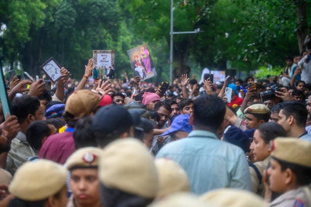 July 20, 2026, New Delhi, New Delhi, India: NEW DELHI, India Ã¢â‚¬ Protesters hold up a copy of India s Constitution and portraits as police officers stand amid the crowd at Jantar Mantar during demonstrations by the Cockroach Janata Party (CJP) demanding the resignation of Education Minister Dharmendra Pradhan over alleged irregularities in the NEET-UG exam, July 20, 2026. New Delhi India  - ZUMAm184 20260720_zip_m184_035 Copyright: xAnkitxRoyxMajumderx