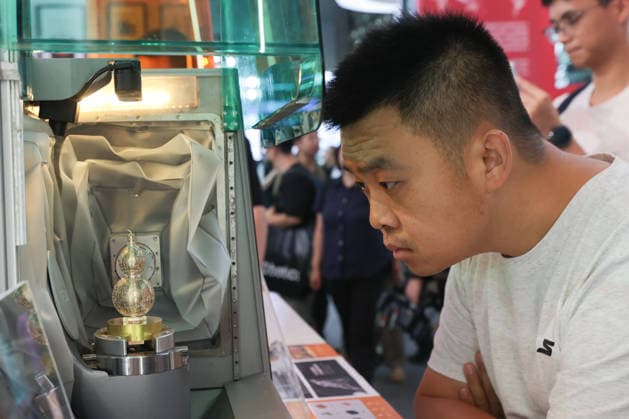 SHANGHAI, CHINA - JULY 20: A visitor learns about a multifunctional desktop five-axis CNC machine designed for automatically generating 3D models and customizing parts during the 2026 World Artificial Intelligence Conference on July 20, 2026 in Shanghai, China. The 2026 World AI Conference and High-Level Meeting on Global AI Governance scheduled from July 17 to July 20 showcases exhibitions of smart devices, AI plus culture and entertainment experiences, and a wide range of cutting-edge AI products, among which a range of humanoid robots and AI-powered dexterous hands as one of the highlights.  Copyright: xChinaxNewsxServicex 111655402362