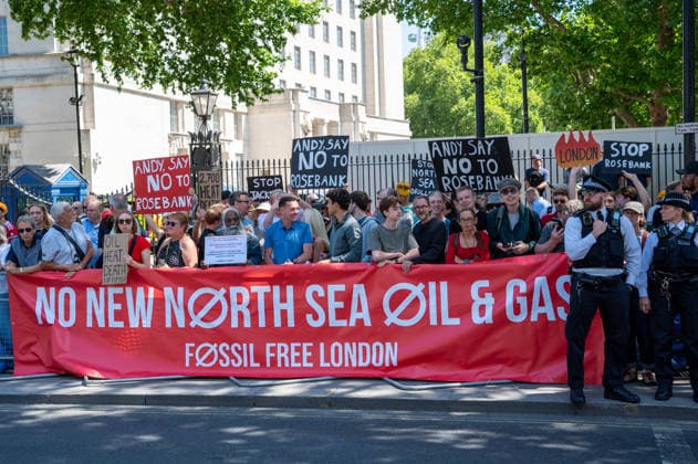 Fossil Free London Protest in London, UK - 20 Jul 2026 Activists hold placards and stand behind a banner expressing their opinion during a protest prior to the swearing-in of Prime Minister Andy Burnham outside Downing Street. Fossil Free London activists protest outside Downing Street as Andy Burnham is sworn in as Prime Minister, urging him to reject the Rosebank oil field and new North Sea drilling. Protesters held placards highlighting heat deaths and UK wildfires alongside a banner reading Stop Rosebank . The action follows reports that the new government could approve Rosebank within days and is the latest in a series of high-profile protests against new fossil fuel extraction. London United Kingdom Copyright: xJamesxWilloughbyx xSOPAxImagesx JWILLOUGHBY_3053