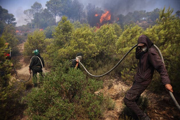 Firefighters battle forest fires in Bouira, Algeria BOUIRA, ALGERIA - JULY 21: Civil defense and firefighting teams battle flames spreading through a forested mountainous area in El Hachimia, Bouira province, on July 21, 2026 in Bouira, Algeria. Crews continue efforts to bring the forest fires under control and prevent the flames from spreading further. Hamza Zait Anadolu Bouira Algeria. Editorial use only. Please get in touch for any other usage.  Copyright: x2026xAnadoluxHamzaxZaitx