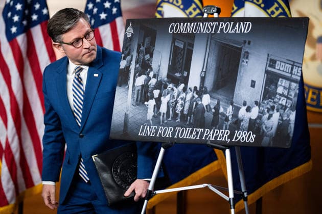Speaker of the House Mike Johnson UNITED STATES - JULY 21: Speaker of the House Mike Johnson, R-La., looks at the Communist Poland line for toilet paper poster on stage as he arrives for the House Republican Conference news conference following their caucus meeting in the U.S. Capitol on Tuesday, July 21, 2026. (Bill Clark CQ Roll Call) Washington DC United States EDITORIAL USE ONLY Copyright: x 2026xCQxRollxCallx BillxClarkx rollcallpix172051