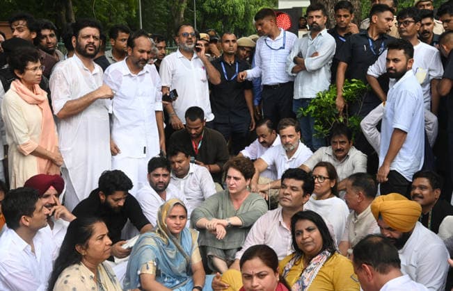 NEW DELHI, INDIA - JULY 21: Leader of Opposition in the Lok Sabha Rahul Gandhi with Priyanka Gandhi Vadra, Kerala Chief Minister VD Satheesan, Congress MP KC Venugopal, and others, stages a sit-in protest near the Prime Minister s residence in solidarity with students protesting over alleged irregularities in the NEET examination, on July 21, 2026 in New Delhi, India. The spontaneous demonstration at Lok Kalyan Marg unfolded a day after security forces used tear gas and lathi charges to disperse student marchers led by the Cockroach Janata Party (CJP) near Parliament Street. Rahul Gandhi demanded the immediate resignation of Union Education Minister Dharmendra Pradhan and an urgent, dedicated debate in Parliament regarding the NEET paper l