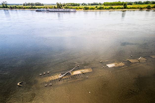 Low water reveals remains of century-old ship on Croatia s Danube An aerial view shows the remains of a ship believed to be more than a century old after record-low water levels in the Danube River exposed the wreck in Opatovac, Croatia, on July 21, 2026. The vessel is believed to have sunk between the two World Wars.  DavidxJerkovic PIXSELL