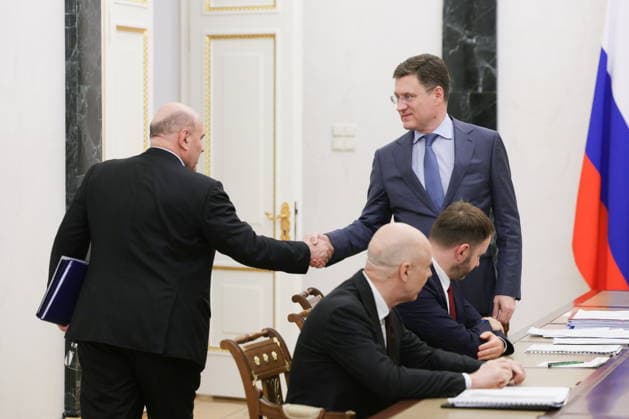 RUSSIA, MOSCOW - JULY 22, 2026: Russia s Prime Minister Mikhail Mishustin and Russia s Deputy Prime Minister Alexander Novak (L-R standing) shake hands during a government meeting chaired by Russia s President Putin (not pictured) to discuss economic issues. Alexander Kazakov Russian Presidential Press and Information Office TASS  95321086