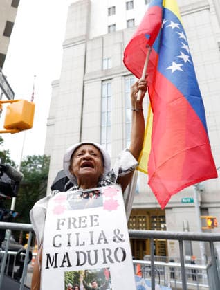 Protesters gather outside at Manhattan Court where ousted Venezuelan President Nicolas Maduro will appear for a hearing on Wednesday, July 22, 2026 in New York City. Venezuela s ousted President Nicolas Maduro and his ?wife ?Cilia Flores are back in a U.S. ?court on Wednesday for a hearing over the upcoming schedule in their drug trafficking case, including a possible ?June 2027 trial start date.  NYP20260722103 JOHNxANGELILLO