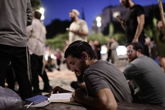 July 22, 2026, Tel-Aviv, Israel: TEL AVIV, ISRAEL Ã¢â‚¬ JULY 22, 2026: Dozens of Jewish worshippers gather at Dizengoff Square in central Tel Aviv for a public reading of the Book of Lamentations on the eve of Tisha B Av, the annual Jewish day of mourning commemorating the destruction of the First and Second Temples in Jerusalem. The observance is marked by prayers, fasting and the reading of biblical texts recalling the tragedies in Jewish history. Tel-Aviv Israel - ZUMAq101 20260722_zna_q101_223 Copyright: xTomerxNeubergx