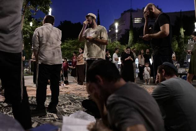 July 22, 2026, Tel-Aviv, Israel: TEL AVIV, ISRAEL Ã¢â‚¬ JULY 22, 2026: Dozens of Jewish worshippers gather at Dizengoff Square in central Tel Aviv for a public reading of the Book of Lamentations on the eve of Tisha B Av, the annual Jewish day of mourning commemorating the destruction of the First and Second Temples in Jerusalem. The observance is marked by prayers, fasting and the reading of biblical texts recalling the tragedies in Jewish history. Tel-Aviv Israel - ZUMAq101 20260722_zna_q101_227 Copyright: xTomerxNeubergx