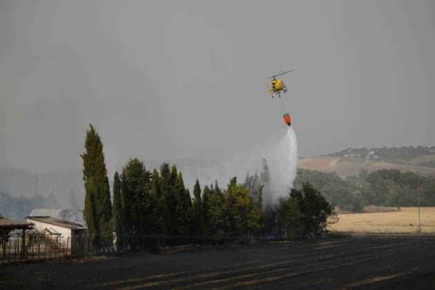 July 22, 2026, Madrid, Spain: MADRID, SPAIN Ã¢â‚¬ JULY 22, 2026: Firefighters work to extinguish a wildfire burning alongside the A-1 motorway near Madrid. Several fire engines and two firefighting helicopters are deployed to contain the blaze and prevent it from spreading. Madrid Spain  - ZUMAq101 20260722_zna_q101_244 Copyright: xTomasxCallex