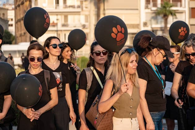 Animal rights activists march in Izmir, Turkey - 22 JULY 2026. Animal rights activists seen holding black balloons with animal footsteps after the march. Animal rights advocates held a silent march in Izmir, Turkey, to call for the protection of stray animals and their right to life. Following the march, participants issued a statement urging humane and permanent solutions for stray animals while calling on the public to defend the right to life and adopt animals from shelters or the streets. Izmir Turkey Copyright: xMuratxKocabasx xSOPAxImagesx DSCF5372