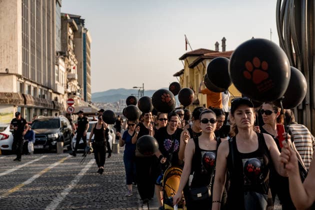 July 22, 2026, Izmir, Turkey: Animal rights activists seen walking on streets while holding black balloons with animal footsteps during their silent march. Animal rights advocates held a silent march in Izmir, Turkey, to call for the protection of stray animals and their right to life. Following the march, participants issued a statement urging humane and permanent solutions for stray animals while calling on the public to defend the right to life and adopt animals from shelters or the streets. Izmir Turkey - ZUMAs197 20260722_aaa_s197_508 Copyright: xMuratxKocabasx