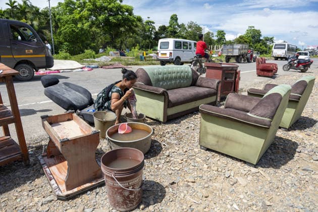 Flood in Indian Northeastern State Assam JORHAT, INDIA - JULY 22: A resident washes clothes beside household furniture placed along a roadside after being evacuated from a flood-affected neighborhood, on July 22, 2026 in Jorhat, India. The flood situation in Assam remained critical, with more than 630,000 people affected across 21 districts. The state’s death toll has risen to 12. David Talukdar Anadolu Jorhat India. Editorial use only. Please get in touch for any other usage.  Copyright: x2026xAnadoluxDavidxTalukdarx