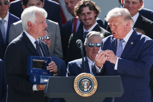 DC: Trump Hosts 2025 MLB World Series Champions LA Dodgers at White House President Donald Trump holds up a ring given to him during an event with the 2025 MLB World Series Champions the Los Angeles Dodgers in the Rose Garden at the White House on July 23, 2026 in Washington, D.C. The Dodgers defeated the Toronto Blue Jays in Game 7 of the 2025 MLB World Series to claim back-to-back championship titles. (Photo by Samuel Corum Pool ABACAPRESS.COM) Washington DC United States  Copyright: xPool ABACAx