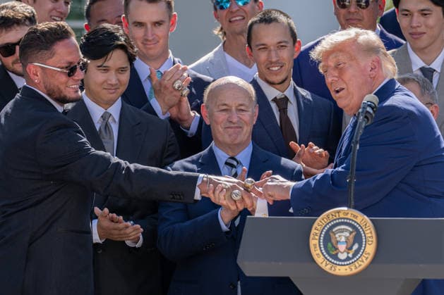 July 23, 2026, Washington, District Of Columbia, Unites States: U.S. President DONALD TRUMP admires the 2025 World Series championship rings of Los Angeles Dodgers infielder MIGUEL ROJAS during a ceremony honoring the 2025 World Series champion Los Angeles Dodgers at the White House. Washington Unites States - ZUMAk206 20260723_znp_k206_036 Copyright: xMattxKaminskyx
