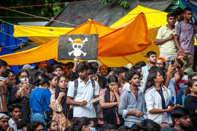 New Delhi Exam Leak Protest A demonstrator holds a placard bearing a skull-and-crossbones symbol above the crowd at Jantar Mantar in New Delhi, India, on July 23, 2026. The Cockroach Janta Party (CJP) organized the youth protest over national examination paper leaks, including NEET and CBSE examinations, and called for the resignation of Union Education Minister Dharmendra Pradhan. New Delhi Delhi India Copyright: xYousufxSarfarazx