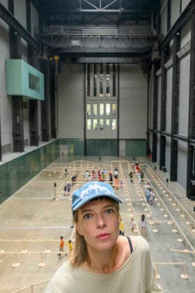 July 24, 2026, London, London, UK: Artist Lina LapelytÄ poses with her created maze-like installation, transforming the Turbine Hall into a collaborative stage. Audiences are invited to co-create in a piece of mass choreography, moving through a grid of wooden barriers. You are also free to quietly watch the performance unfold, from the Turbine Hall bridge. London, UK. London UK  - ZUMAl94_ 20260724_zaf_l94_001 Copyright: xRayxTangx