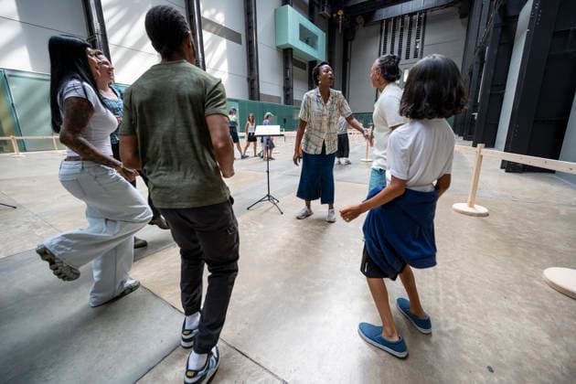 July 24, 2026, London, London, UK: LONDON, UK. Visitors receiving instructions. Preview of UNIQLO Tate Play Lina Lapelyte, Serendipity Island in the Turbine Hall at Tate Modern. Lithuanian born artist Lina Lapelyte (pictured) has created a maze of barriers and encourages visitors to move through, using simple actions such as stomping, jumping and singing, in time with an accompanying soundscape to create a piece of collective choreography. The work is in place 25 July to 31 August 2026. London UK  - ZUMAl94_ 20260724_zaf_l94_028 Copyright: xStephenxChungx