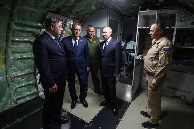 RUSSIA, IRKUTSK - JULY 24, 2026: Andrei Soinov, Irkutsk Aviation Plant CEO, Igor Kobzev (L-R), Irkutsk Region Governor, and Vladimir Putin (2nd R), President of Russia, visit the Irkutsk Aviation Plant owned by Rostec s United Aircraft Corporation. Vyacheslav Prokofyev Russian Presidential Press and Information Office TASS  95394702