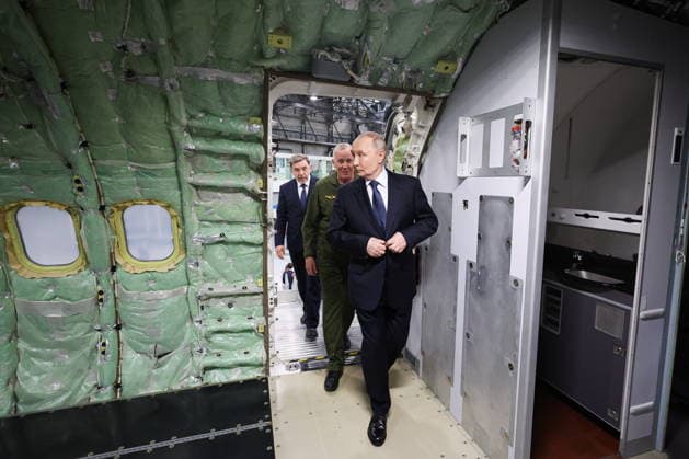 RUSSIA, IRKUTSK - JULY 24, 2026: Vladimir Putin (Front), President of Russia, accompanied by CEO Andrei Soinov (back), visits the Irkutsk Aviation Plant owned by Rostec s United Aircraft Corporation. Vyacheslav Prokofyev Russian Presidential Press and Information Office TASS  95394983