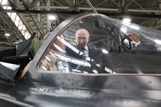 RUSSIA, IRKUTSK - JULY 24, 2026: Vladimir Putin, President of Russia, and Andrei Soinov (L-R back), Irkutsk Aviation Plant CEO, visit the Irkutsk Aviation Plant owned by Rostec s United Aircraft Corporation. Vyacheslav Prokofyev Russian Presidential Press and Information Office TASS  95394987