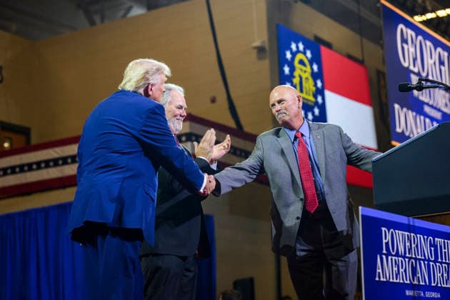 July 24, 2026, Marietta, Ga, United States: U.S. President Donald Trump, left, thanks Brian Snitker, retired manager of the Atlanta Braves, right, and Atlanta Braves executive Mike Plant, center, before delivering remarks on Trump Accounts and the economy at Wheeler High School, July 22, 2026, in Marietta, Georgia. Marietta United States - ZUMAp138 20260724_zaa_p138_017 Copyright: xMollyxRiley WhitexHousex