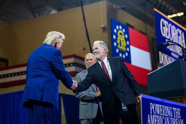 July 24, 2026, Marietta, Ga, United States: U.S. President Donald Trump, left, thanks Atlanta Braves executive Mike Plant, right, and Brian Snitker, retired manager of the Atlanta Braves, center, before delivering remarks on Trump Accounts and the economy at Wheeler High School, July 22, 2026, in Marietta, Georgia. Marietta United States - ZUMAp138 20260724_zaa_p138_031 Copyright: xMollyxRiley WhitexHousex