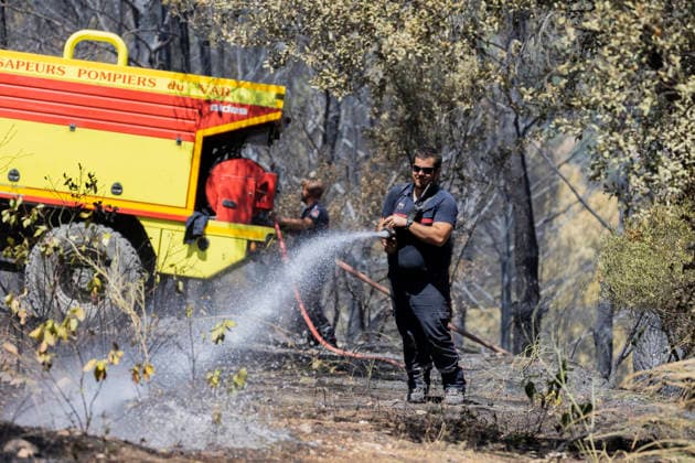 Wildfires in the Var - Cotignac - France A firefighter extinguishes remaining hotspots beside a fire engine after a major wildfire near Cotignac, fire crews continue mop up operations to prevent the wildfire from reigniting in the burned Mediterranean forest. Var, France, July 24, 2026. Photo by Thibaut Durand ABACAPRESS.COM. Cotignac Provence-Alpes-Cote d Azur France  Copyright: xDurandxThibaut ABACAx
