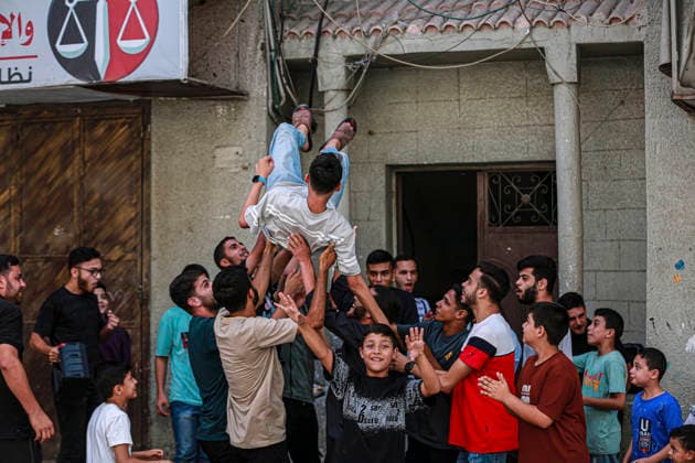 Gaza Families Celebrate Tawjihi Success Palestinian men toss a young man into the air during celebrations of the Tawjihi results in Gaza City, northern Gaza Strip, on July 23, 2026. Families in displacement camps and neighborhoods across northern Gaza City held modest celebrations for students who passed the Tawjihi examinations amid war, blockade and severe humanitarian conditions. Gaza Gaza Strip Palestinian Territories Copyright: xFaizxQreqax